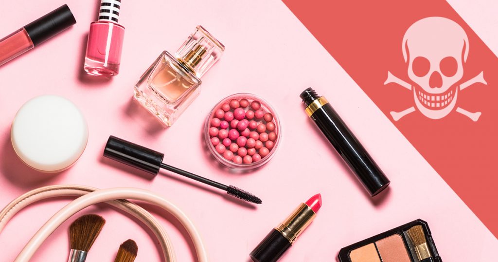 Makeup and perfume beside a skull and crossbones