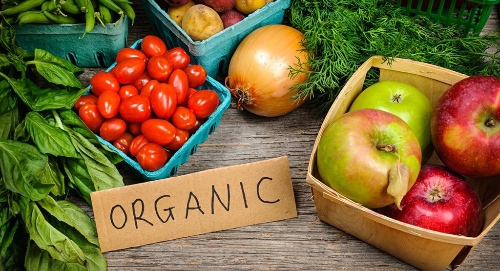 Organic fruits and vegetables on wooden table
